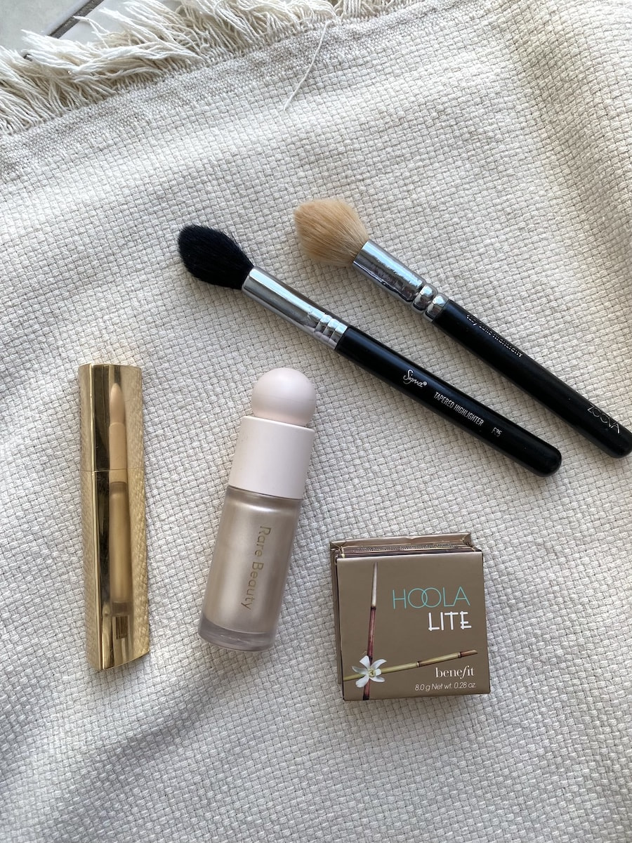 bronzer, highlighter, blush and makeup brushes